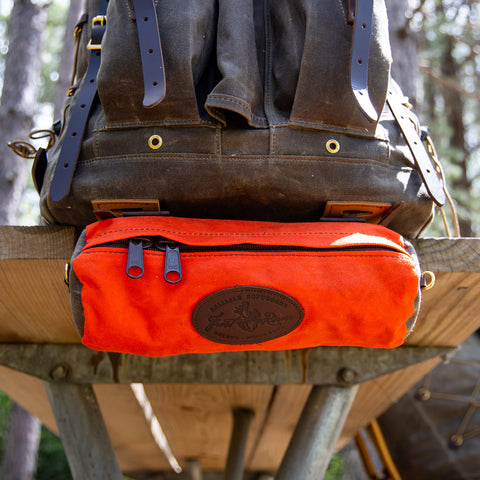 Hunter Orange Sawbill Handlebar Bag strapped to the bottom of an Isle Royale Pack