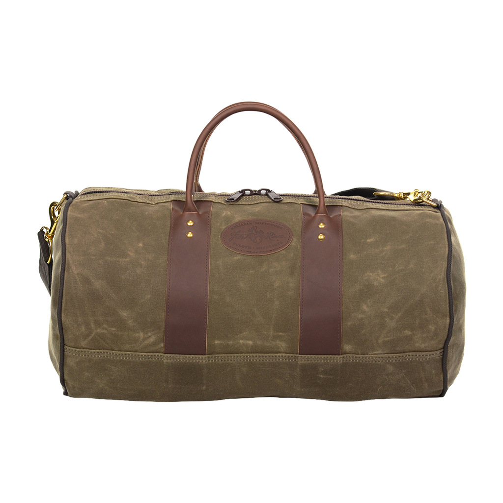 Classic round shaped duffel bag made from 18 ounce waxed canvas, full grain leather, and solid brass hardware.