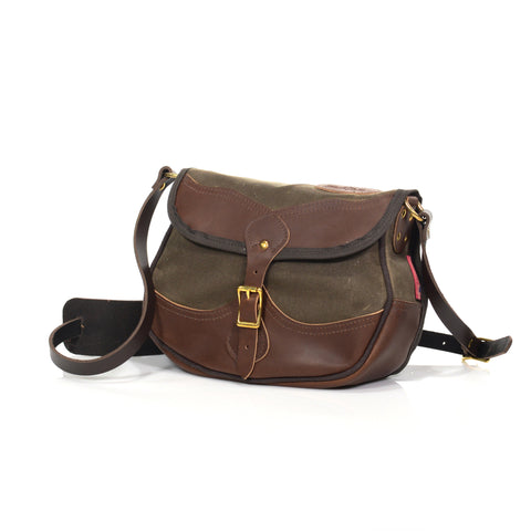 Shoulder strap attachment points are reinforced with rivets and leather backing.