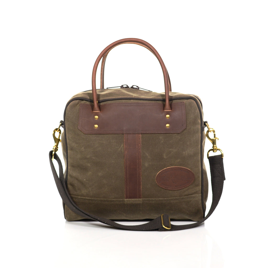 Great luggage tote made from durable waxed canvas, premium leather, and solid brass.