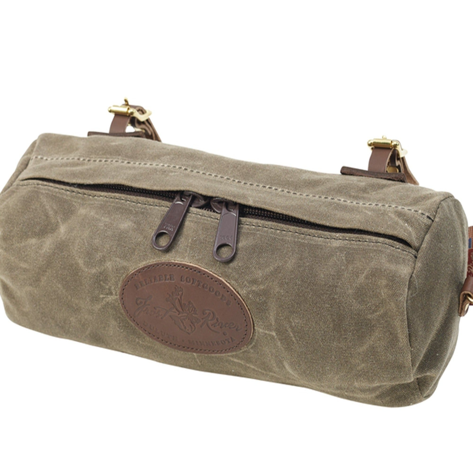 This tubed shaped handle bar bag is crafted out our high quality waxed canvas, premium leather, durable solid brass, and heavy duty zippers. Two zippers open and close this bag.