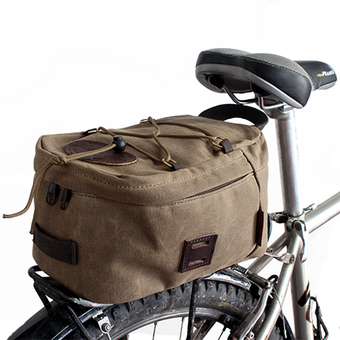 The box shape of the Taconite Trail Bike Trunk bag fits well on a back wheel rack and is secured onto the bike with sturdy leather straps and solid brass buckles.